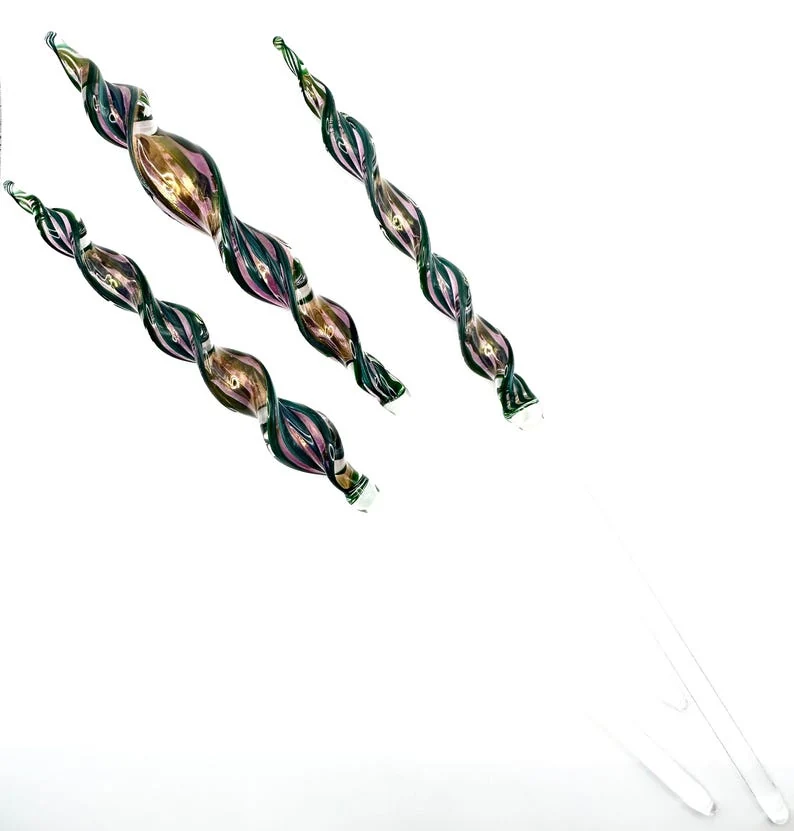 Three twisted glass plant supports with blue, green, and gold ribbons